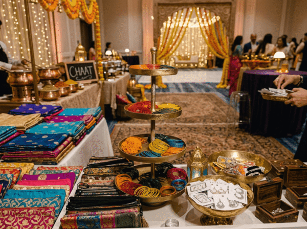 Stacked dupattas in jewel colours beside the brass tiers