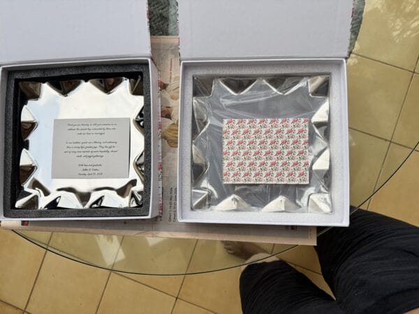 Open boxes showing the stainless steel designer tray and printed card