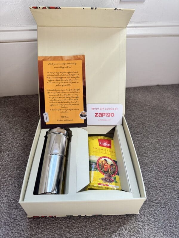 Open return gift box with a stainless steel filter, South Indian filter coffee and a printed card